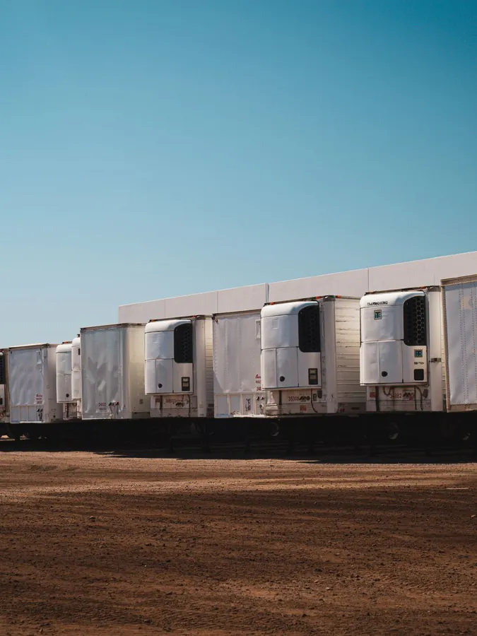 A row of parked transport trailers